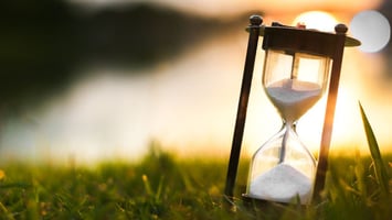 An hourglass lit by golden hour sunlight