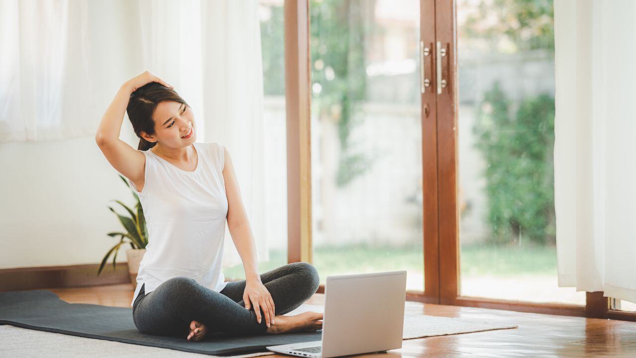 a woman sat doing gentle somatic exercises